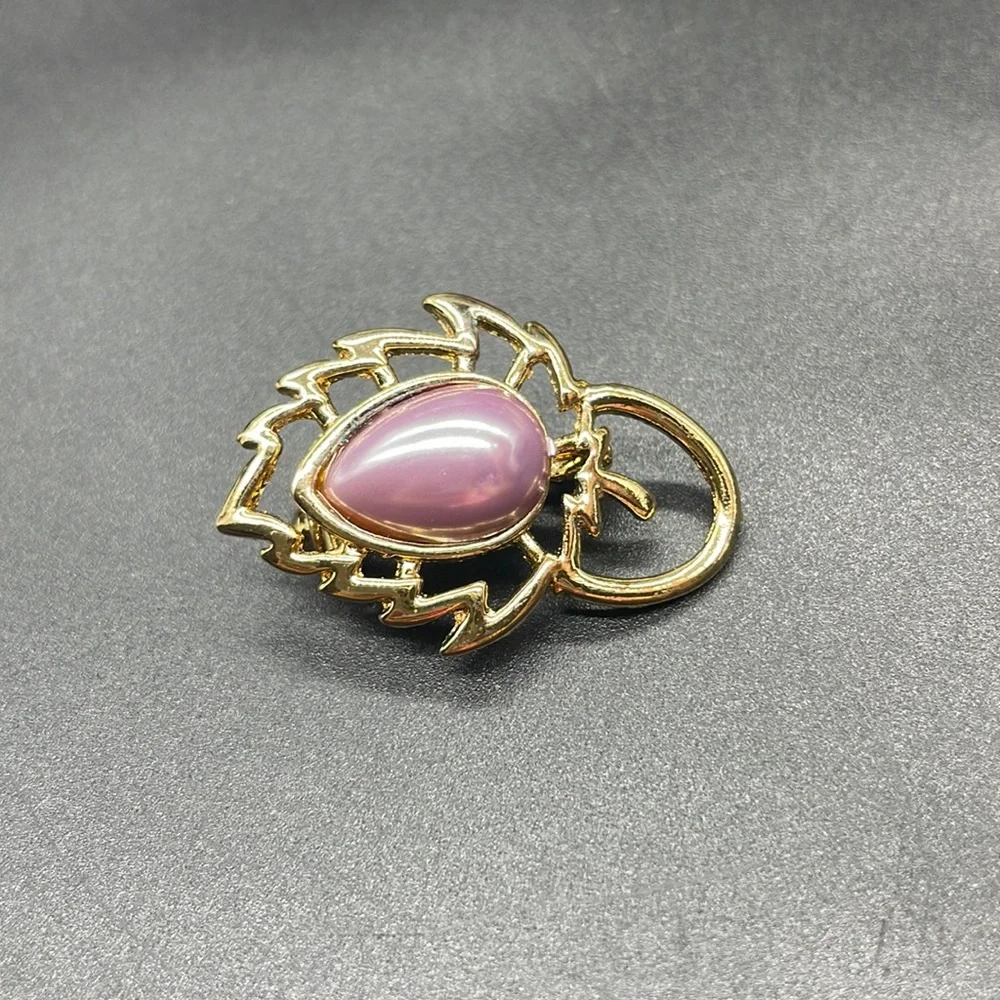 Gold plated brooch with a stone in the center | the stone color is a lavender